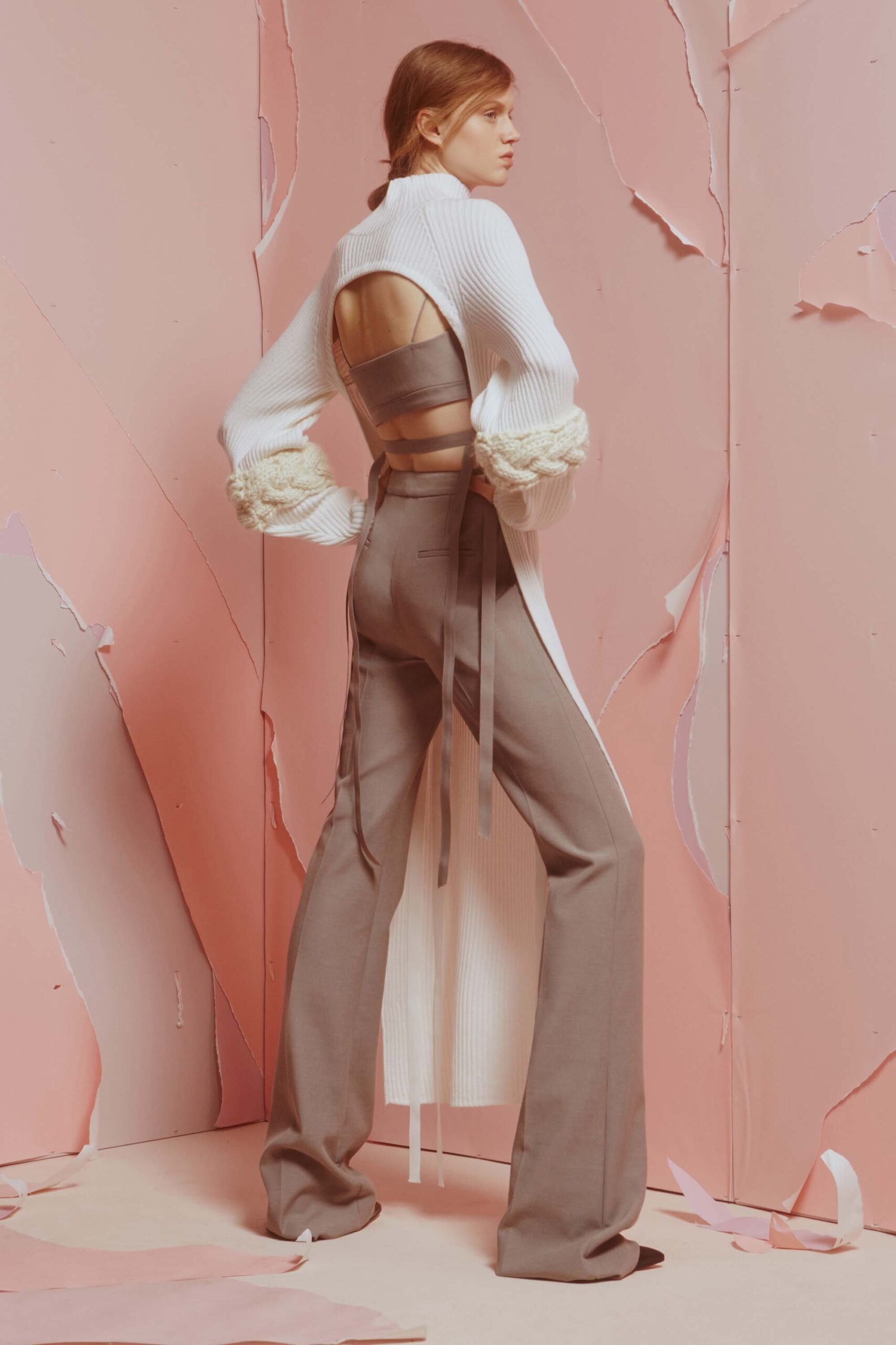 white coat beige top gray pants