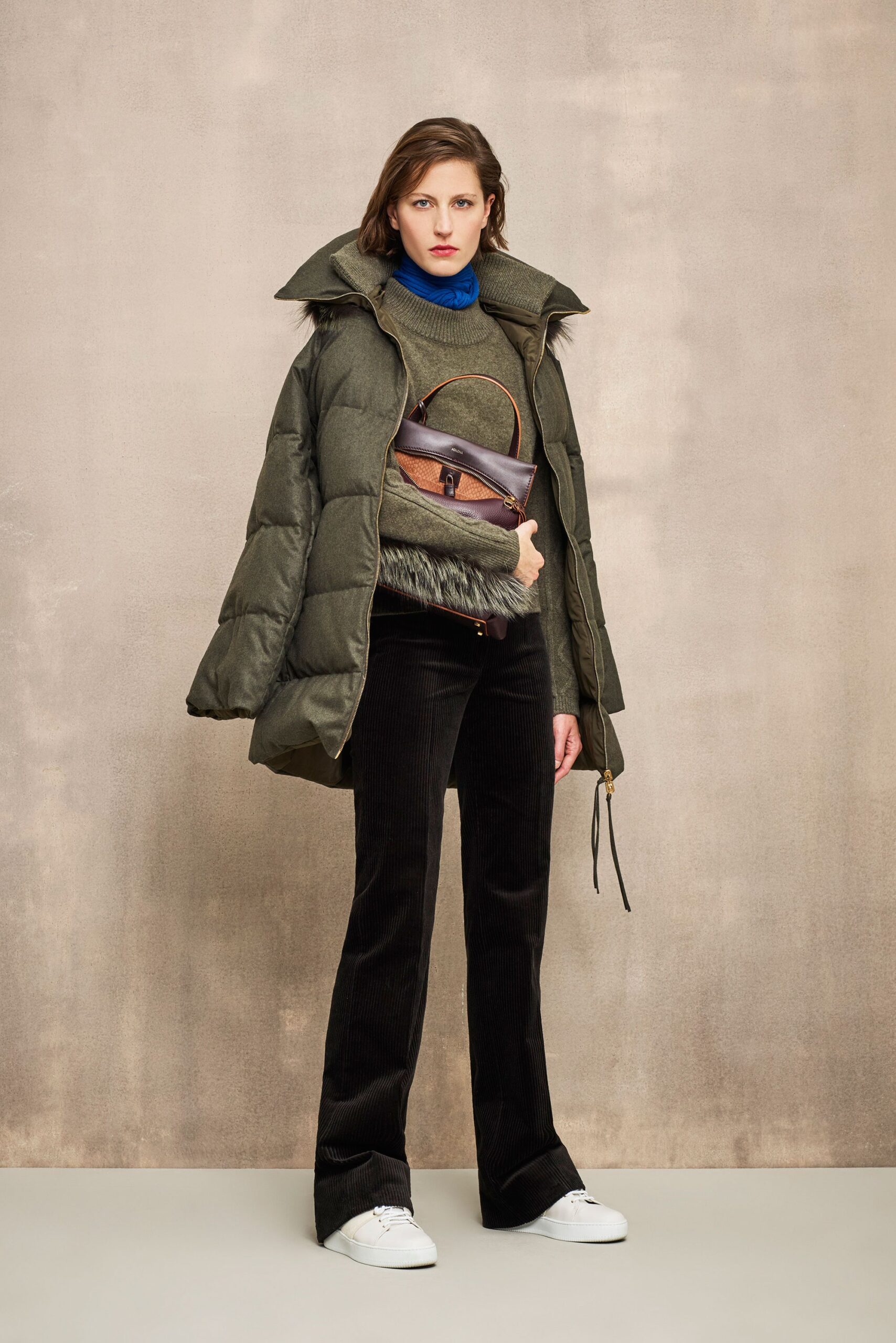 green coat blue sweater black pants