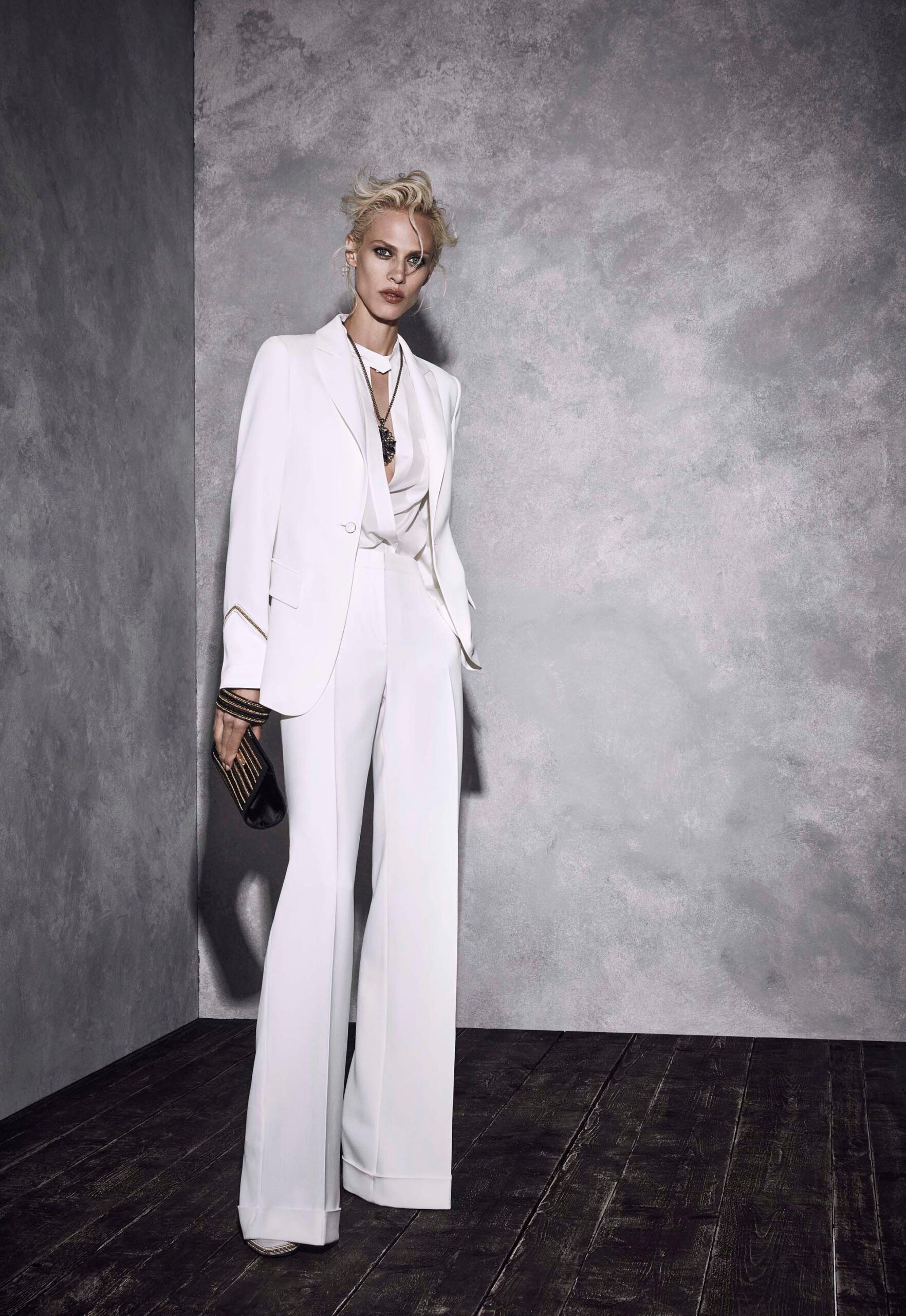 white tailored suit with black bag