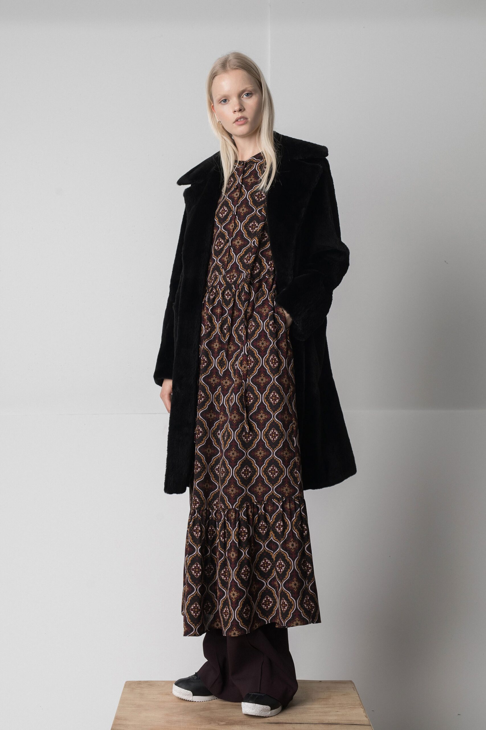 black faux-fur coat with multi dress