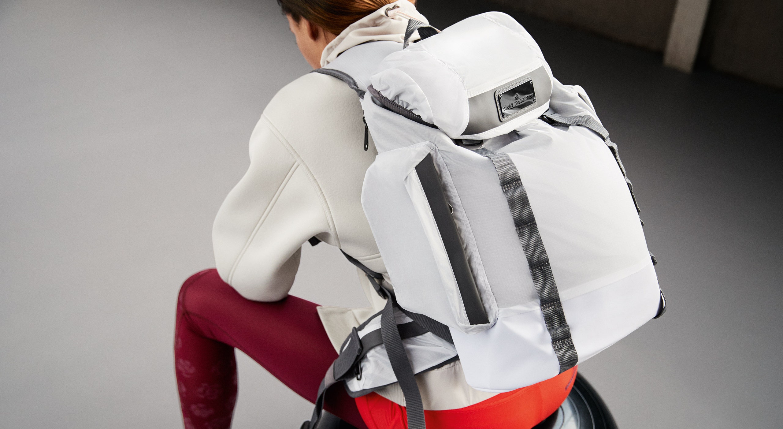 fitted white neoprene top and red pants