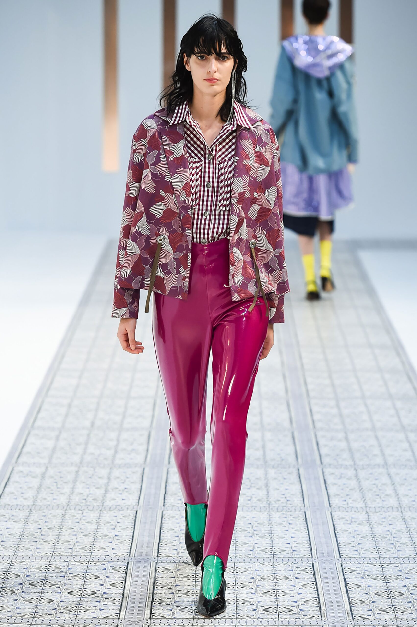 A fitted multicolor printed jacket paired with sleek pink fitted pants.