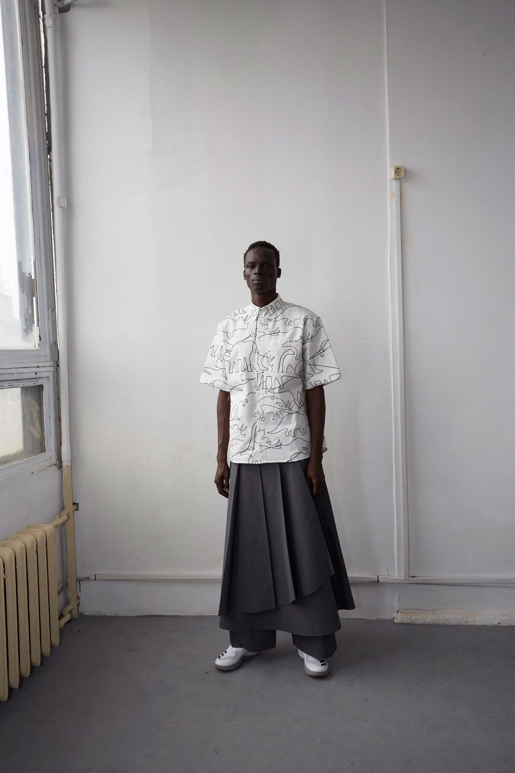 white printed shirt and gray pleated skirt