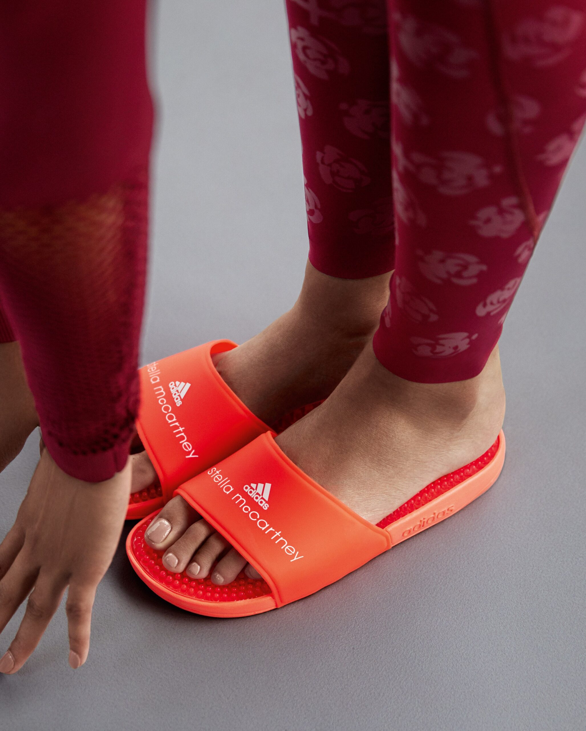 red printed leggings with orange shoes