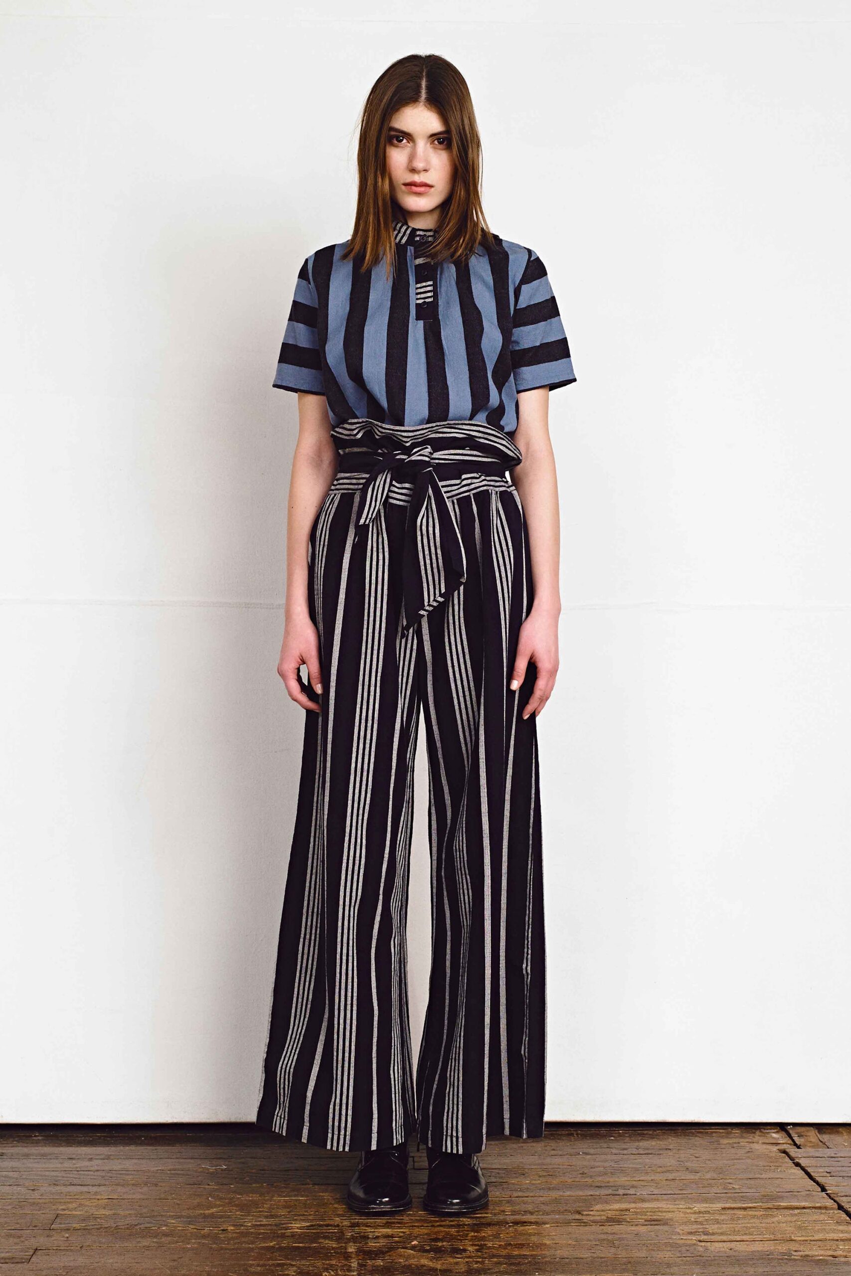 striped blue top and black pants