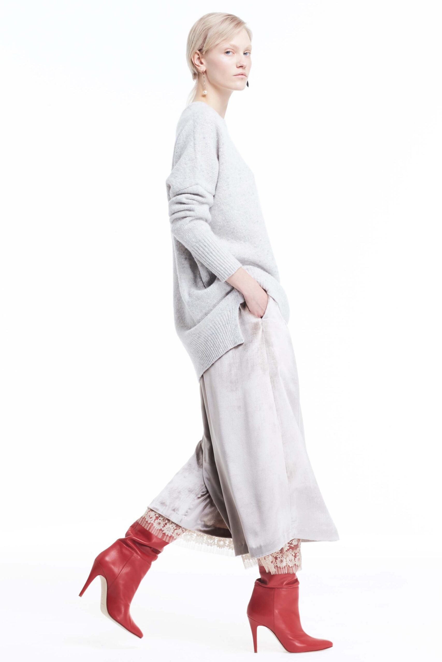 gray oversized sweater with beige pants and red boots