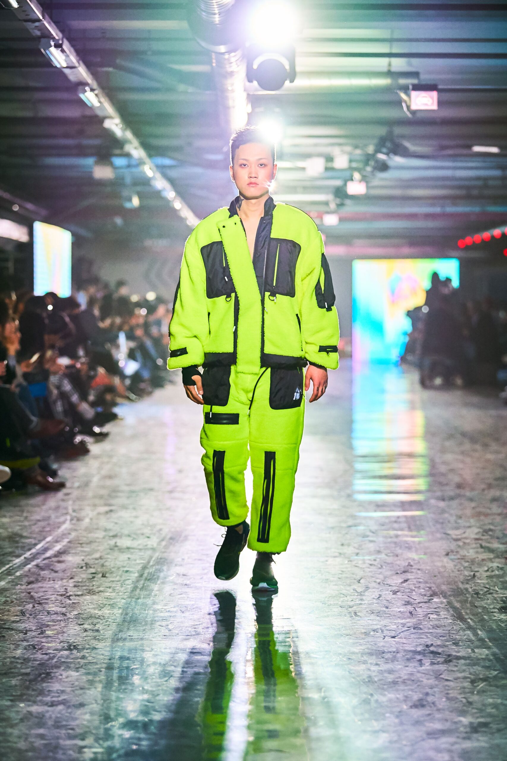 A relaxed green cotton jacket with long sleeves and matching pants featuring zippered pockets.