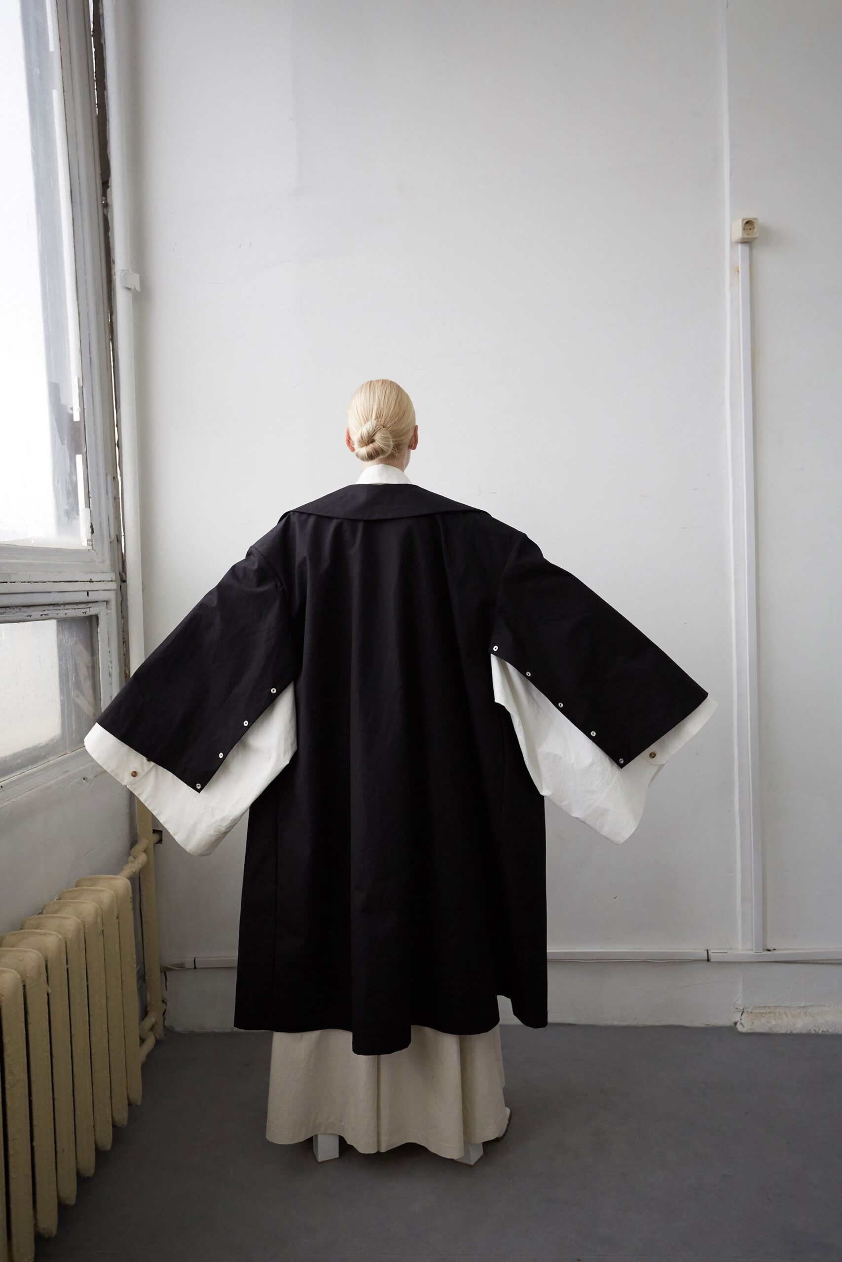 black cotton long-sleeve relaxed layered coat