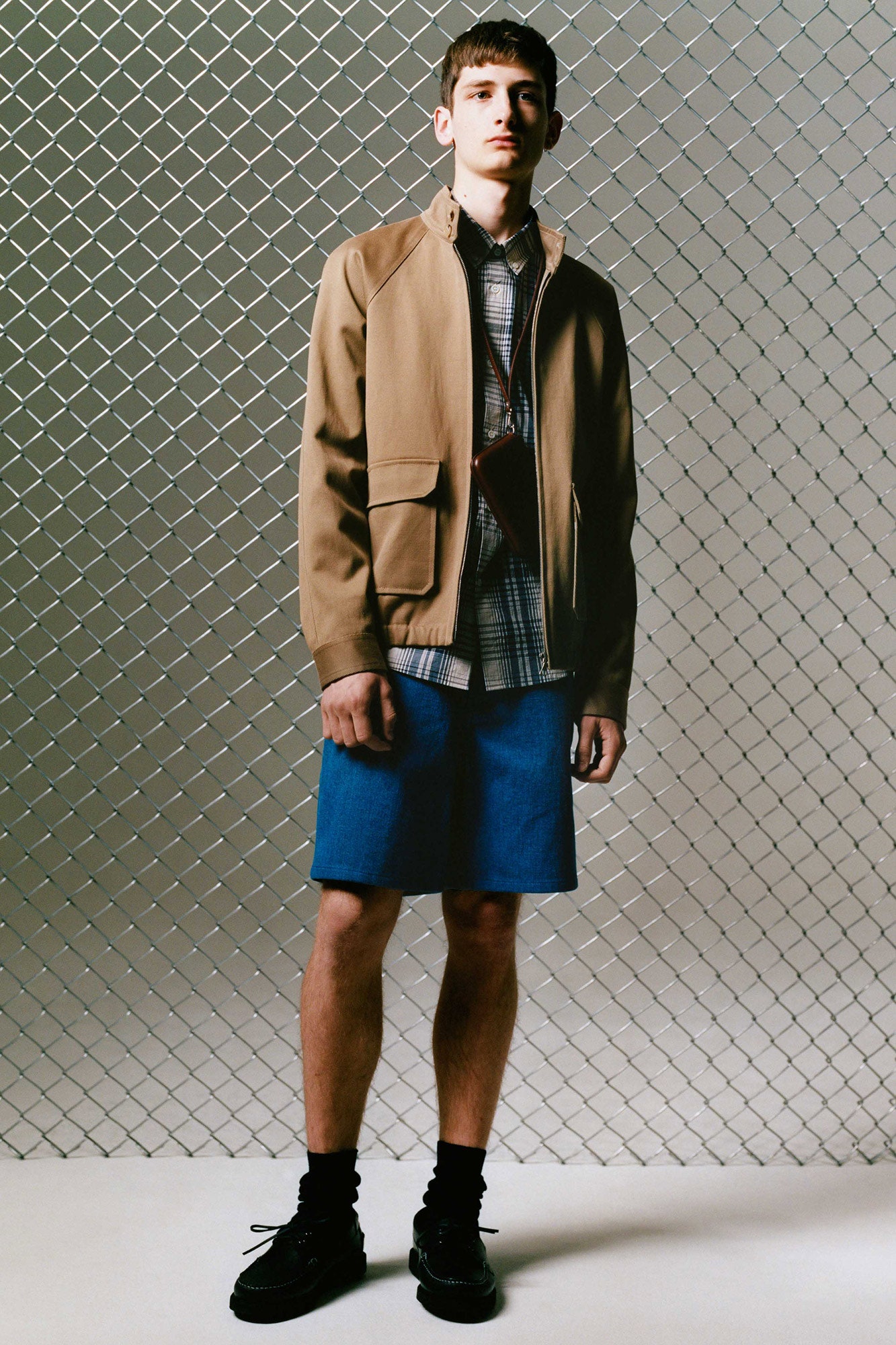 beige jacket with blue shirt and shorts