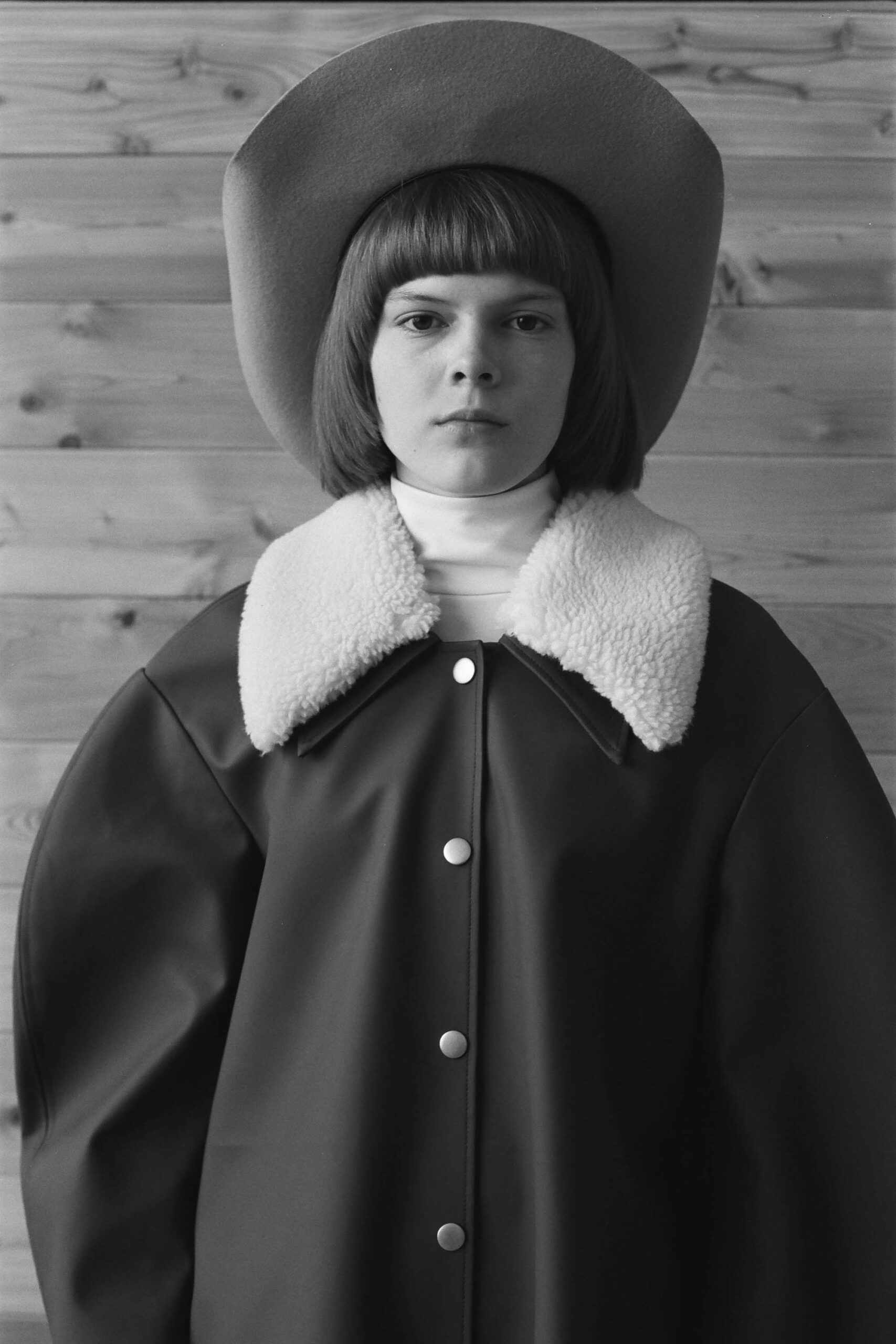 black leather coat with gray hat