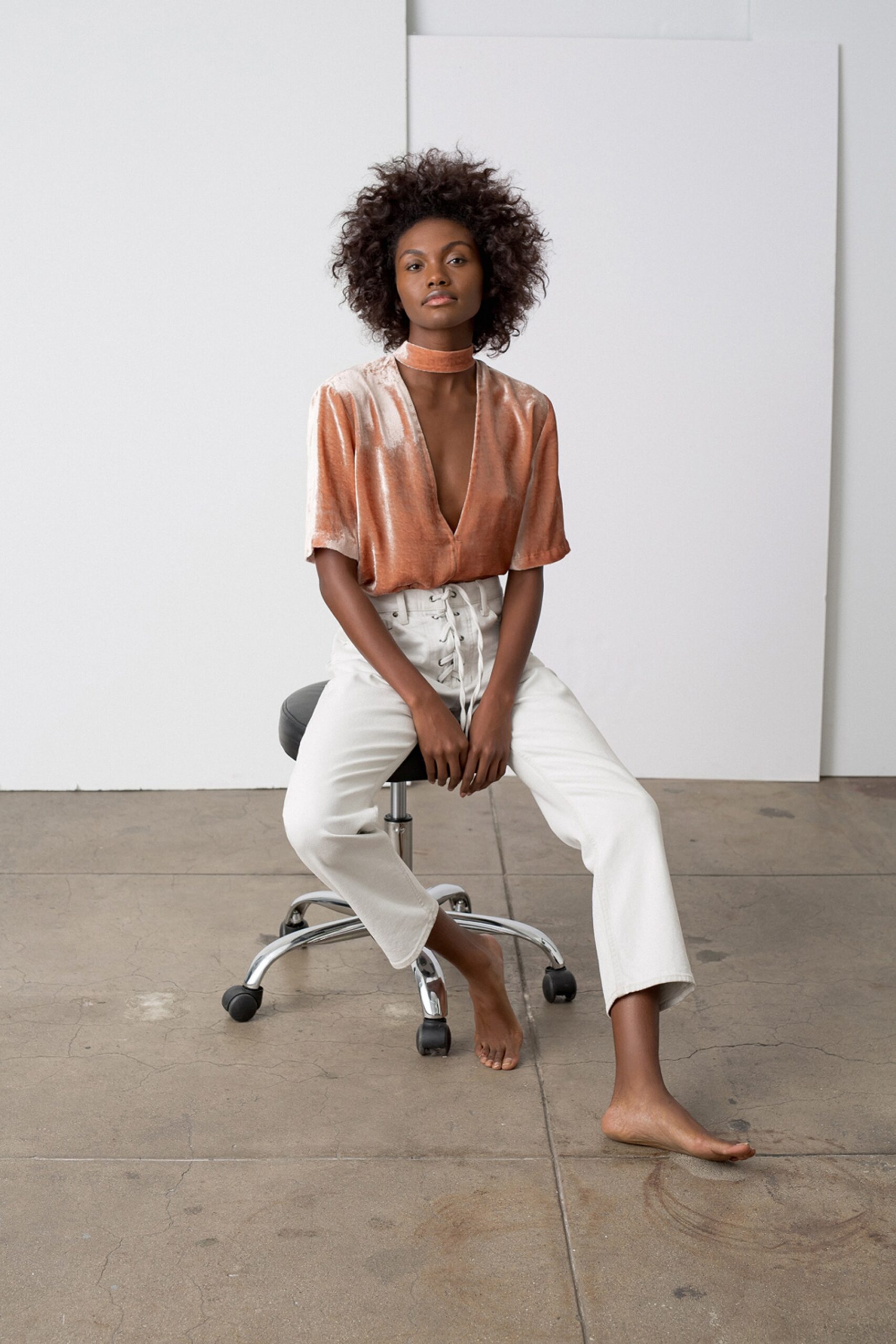orange silk relaxed top with white pants