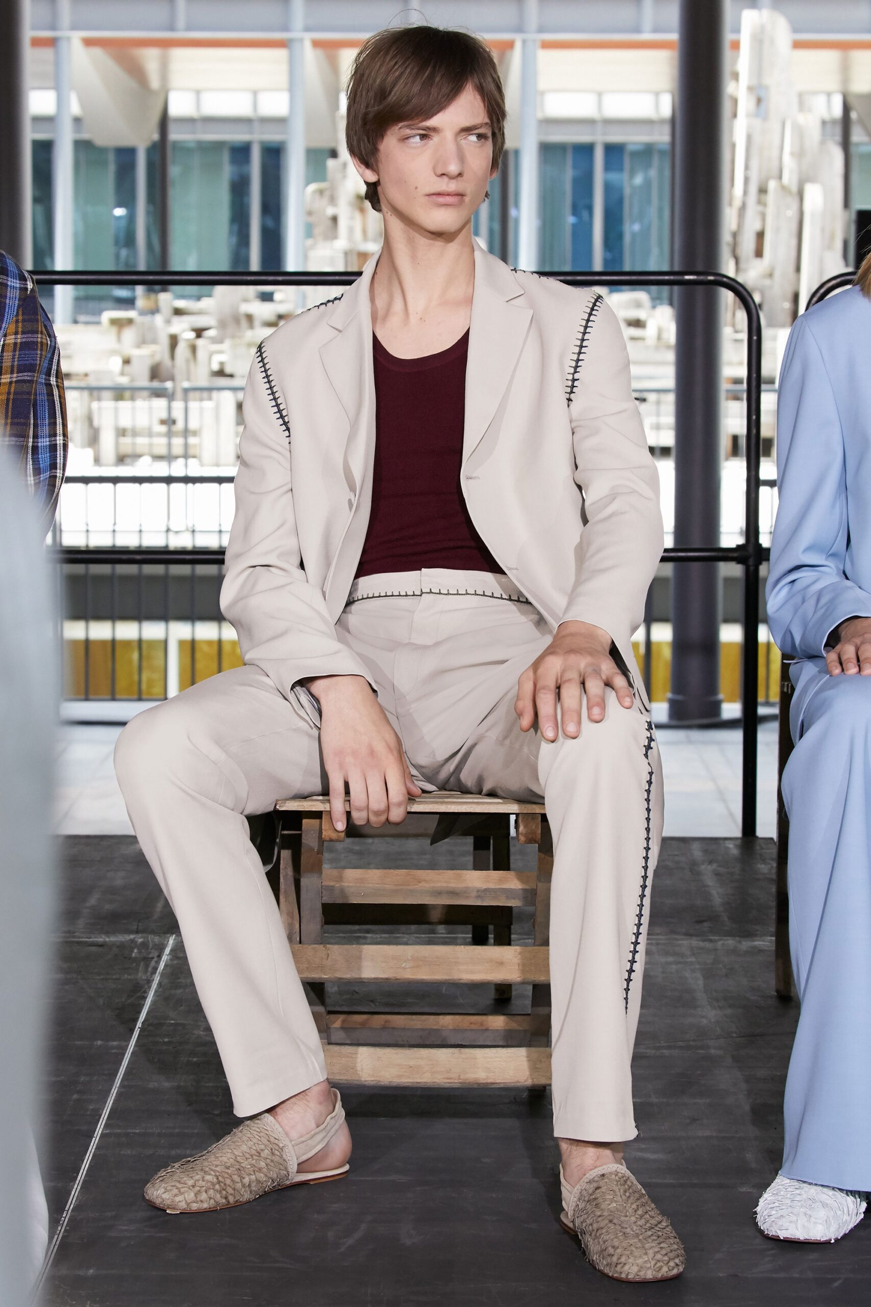 beige tailored suit with red top