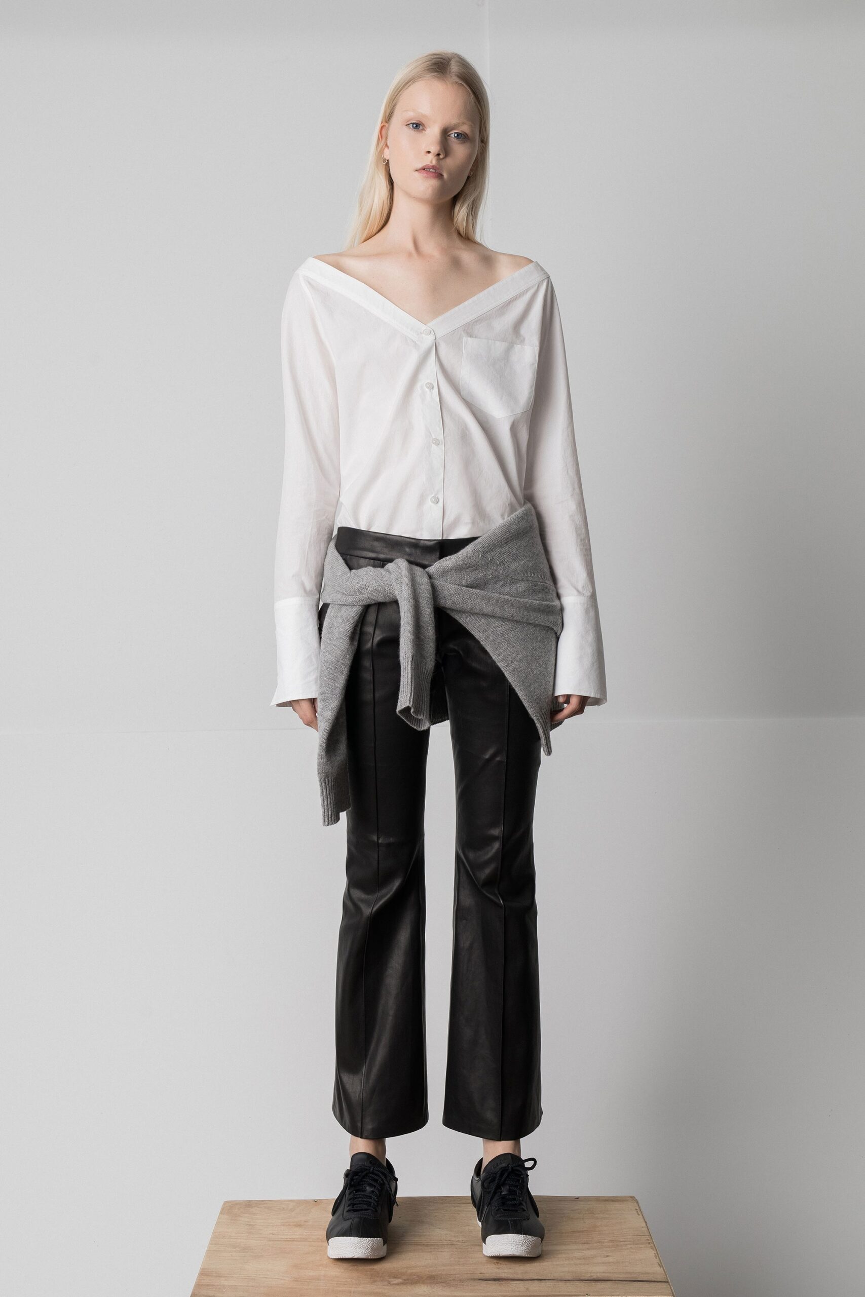 white relaxed shirt with black leather pants