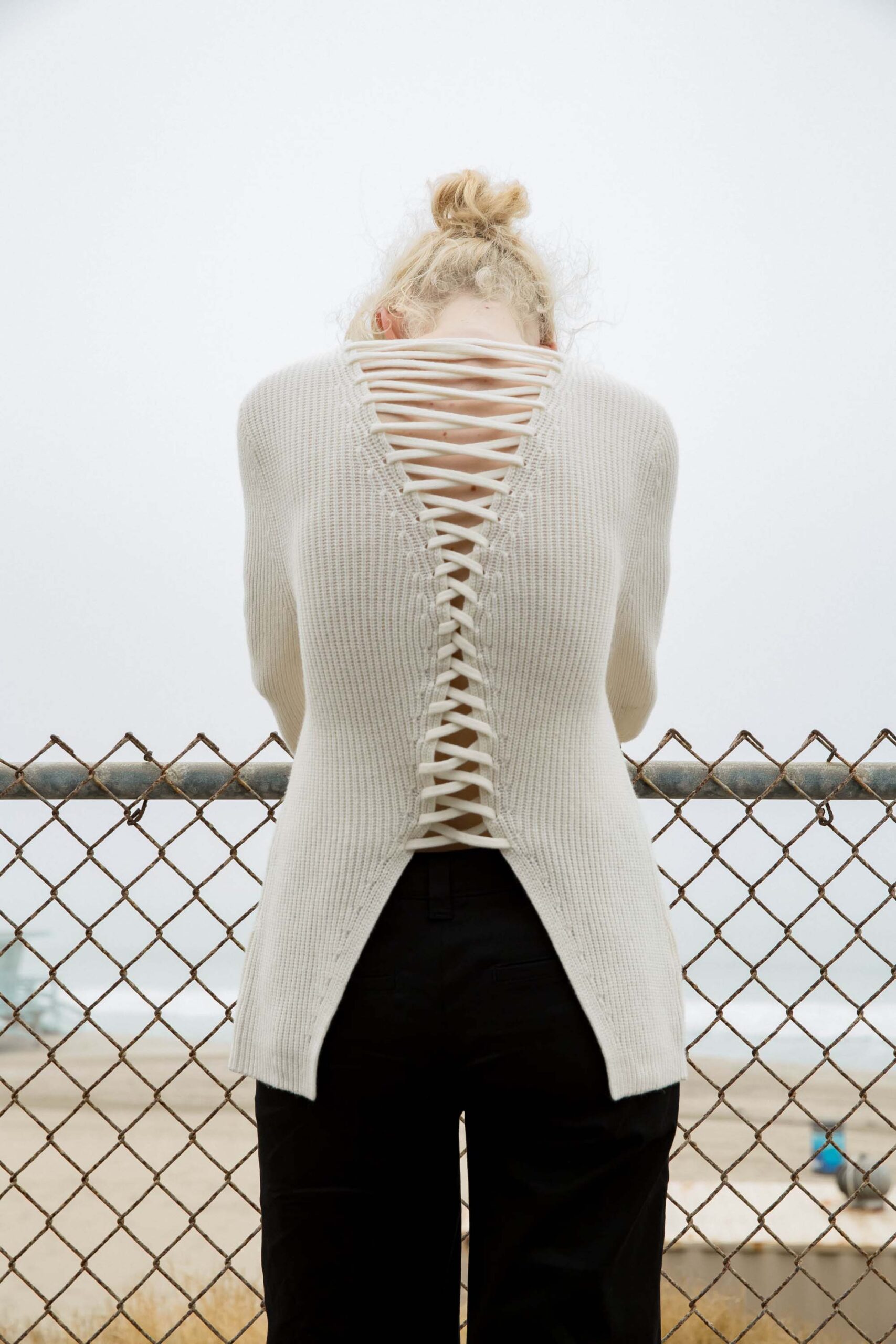 white cutout sweater with black pants