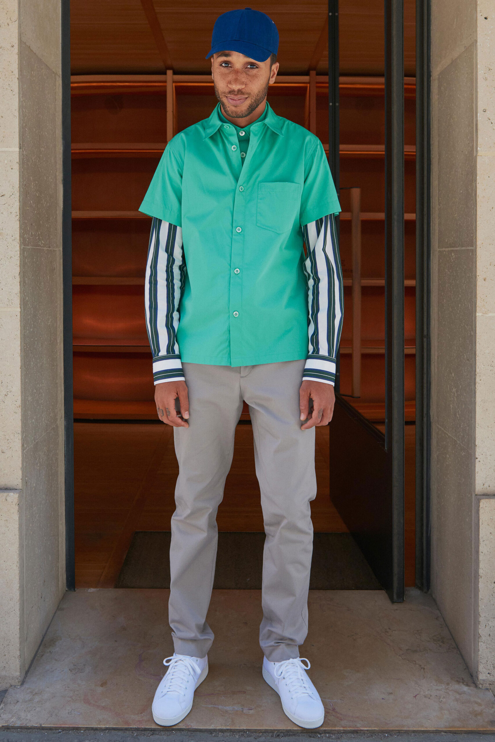 green short-sleeve shirt with beige pants