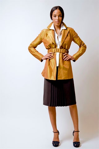 gold silk fitted jacket and brown pleated skirt
