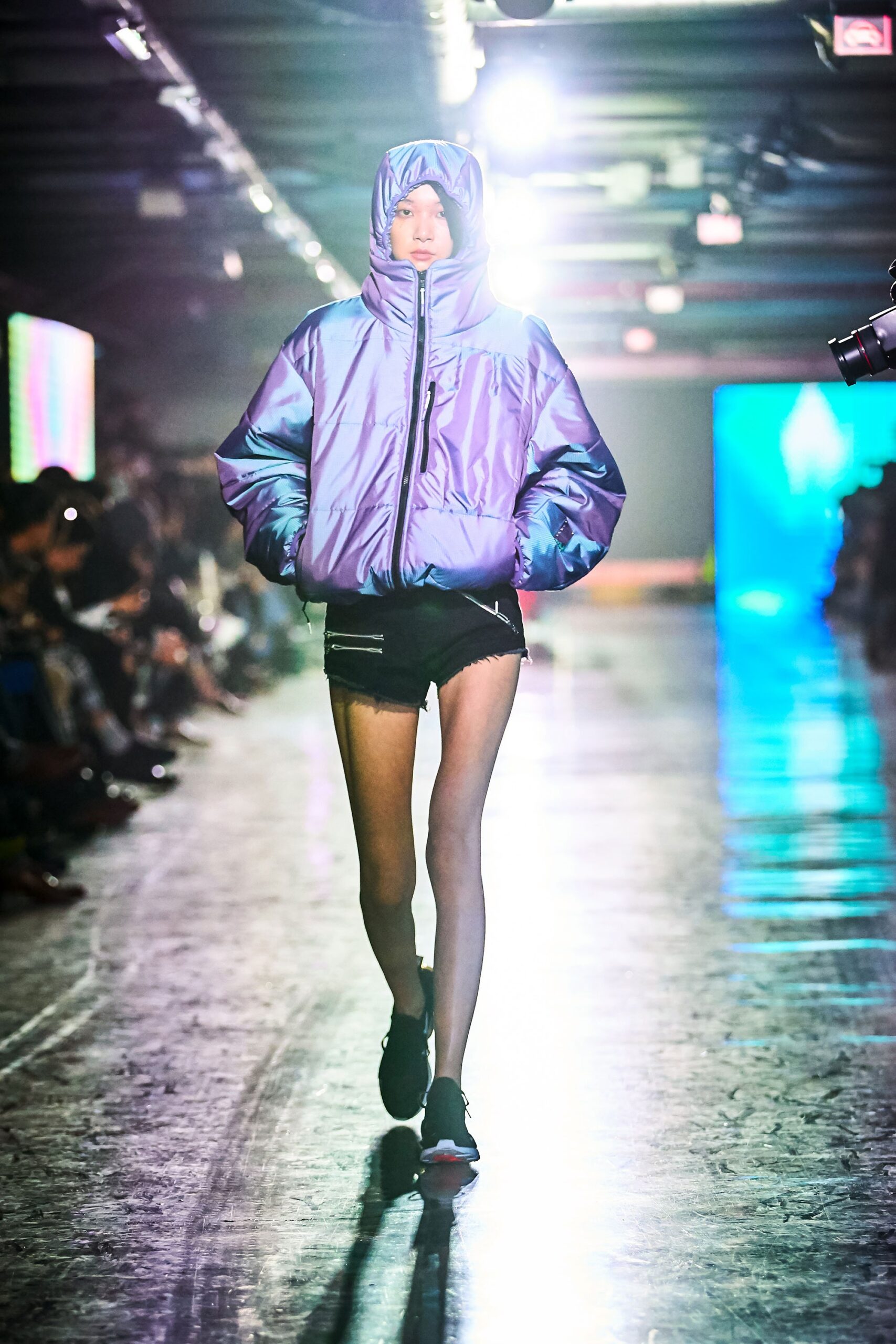 An oversized purple hooded jacket paired with shorts, featuring a zippered design.