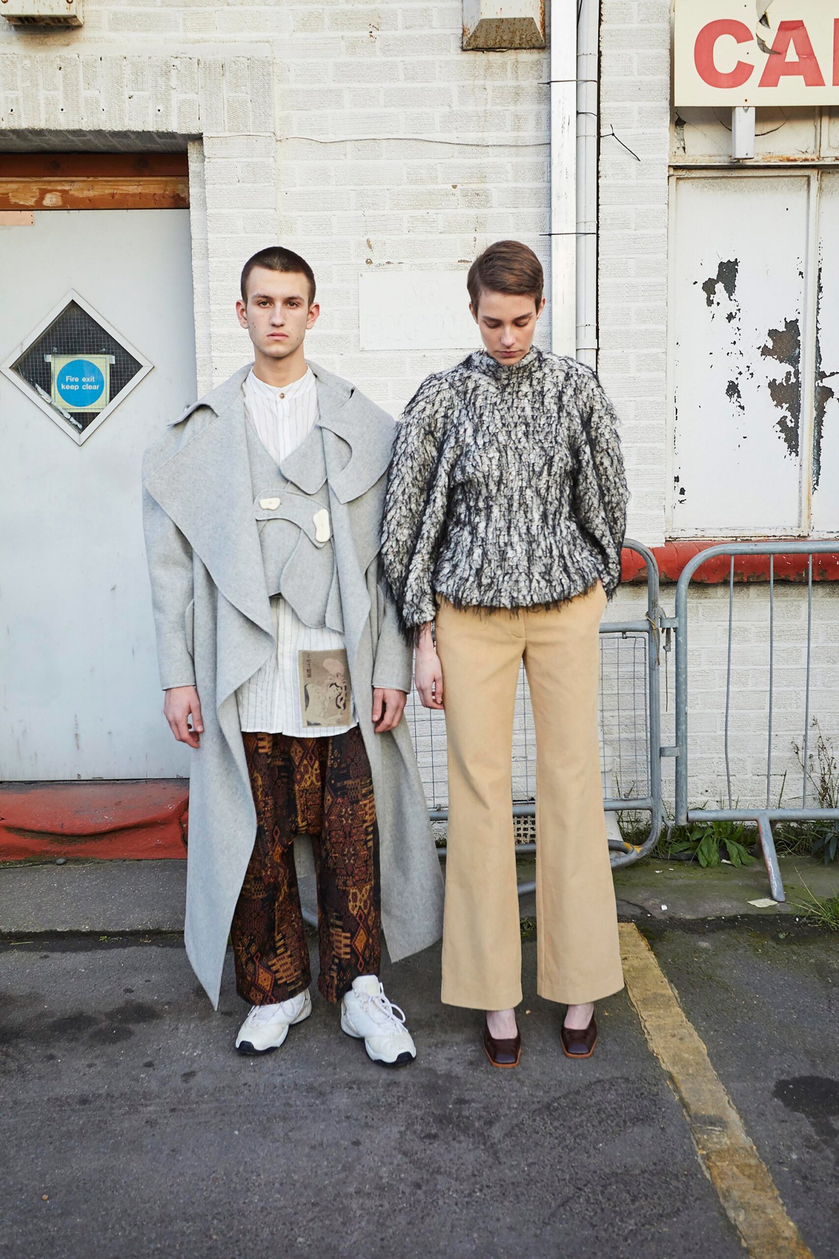 gray oversized coat and brown flared pants