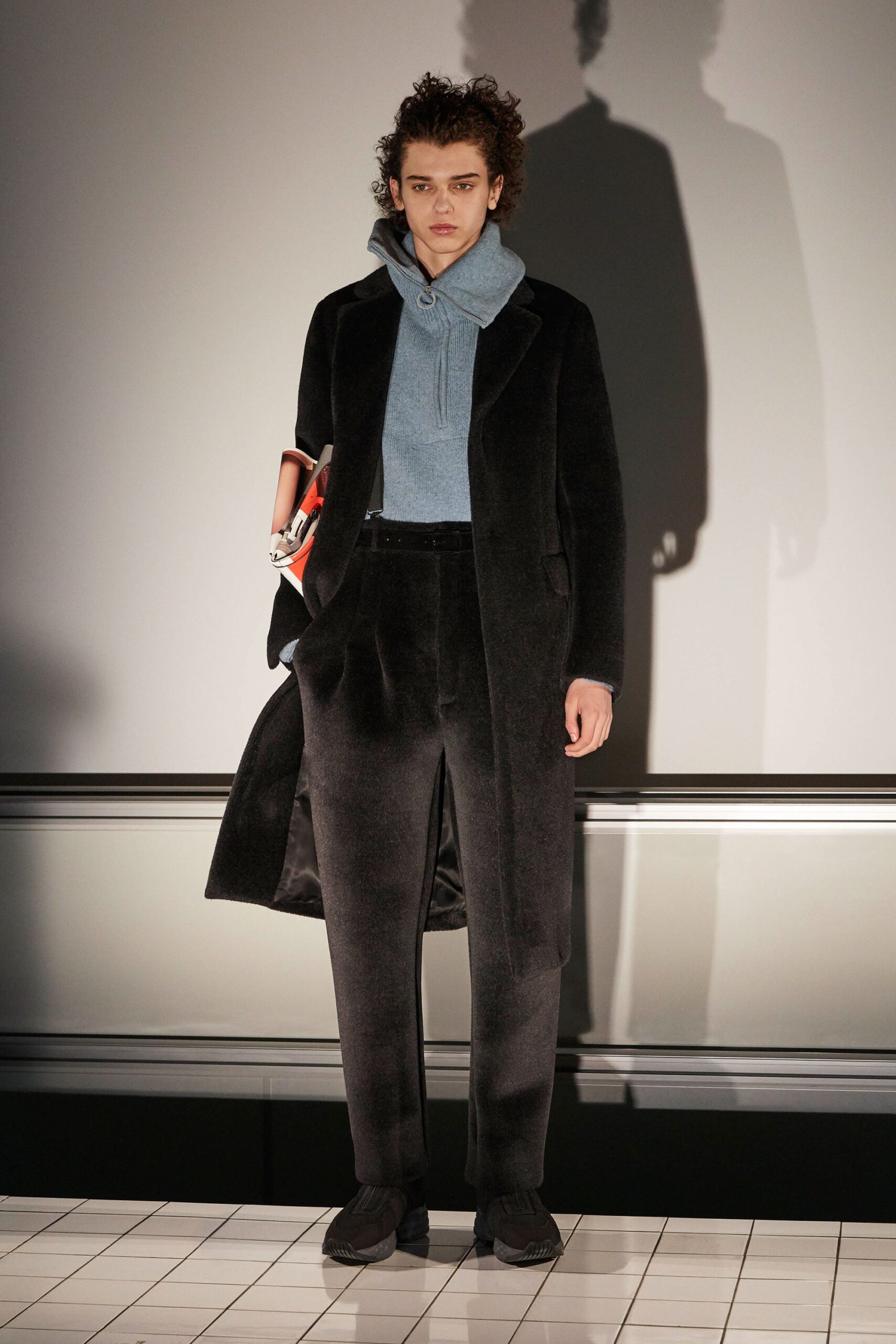 black wool coat blue hoodie tailored pants