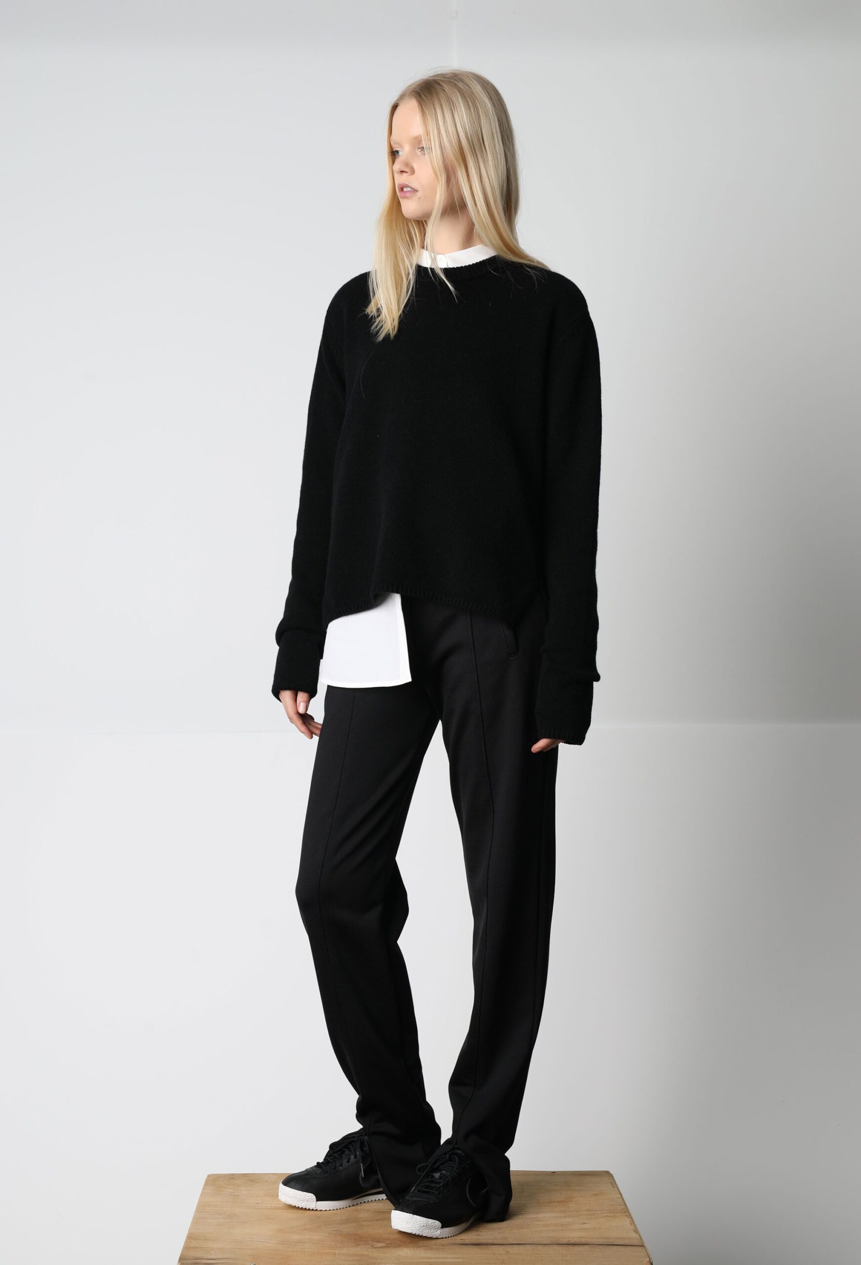 black relaxed sweater and tailored pants