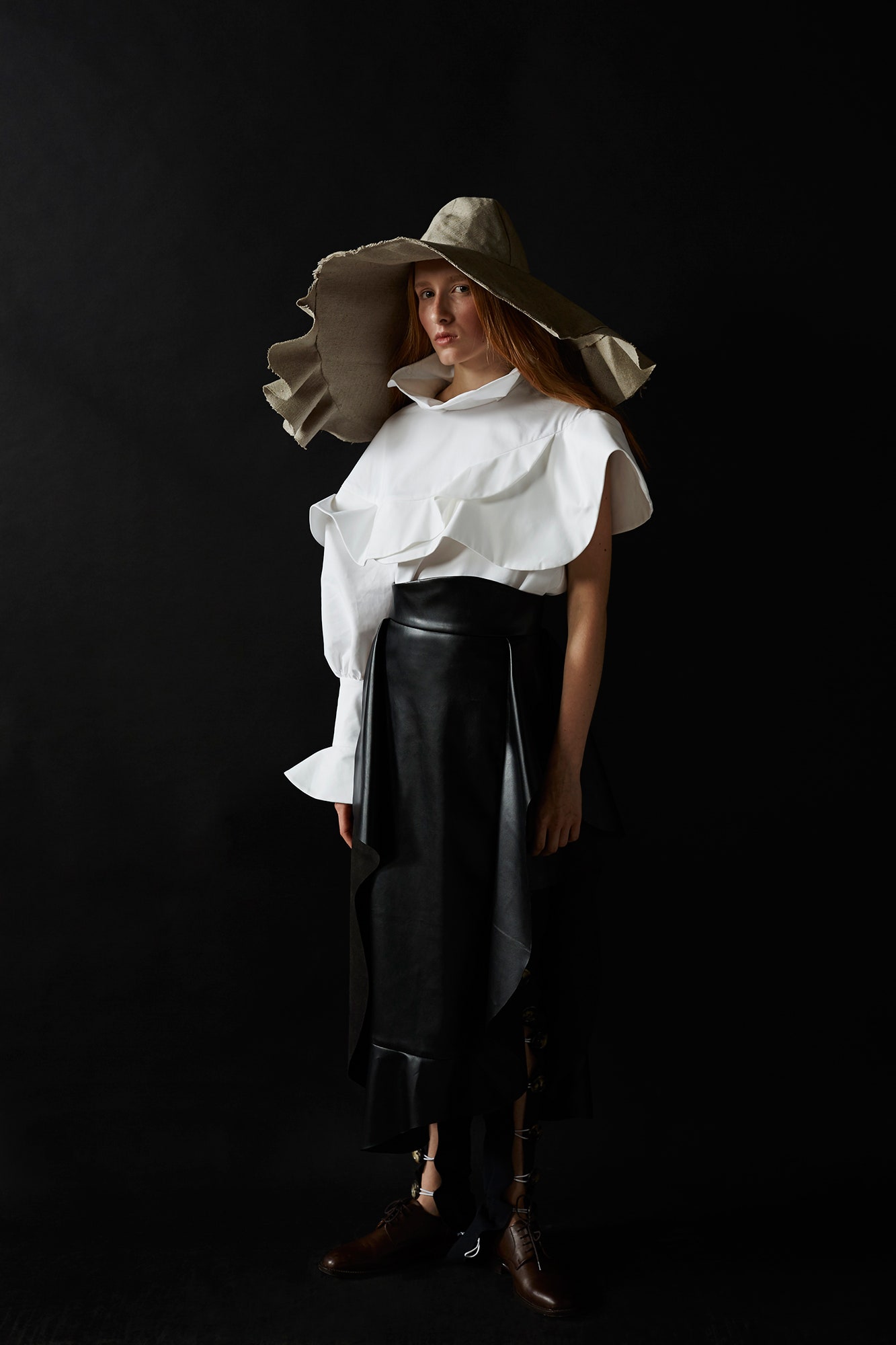 white ruffled top with black leather skirt