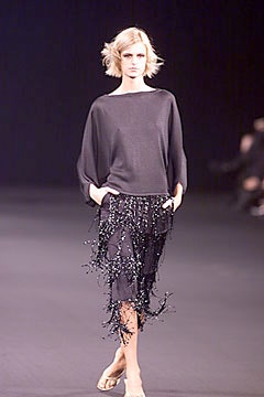 black relaxed top and fringed skirt