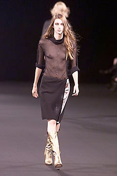 black sheer top and skirt with gold boots