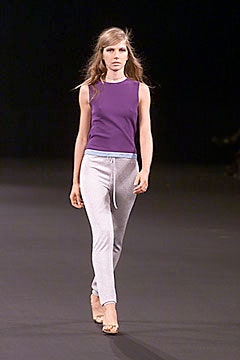purple fitted top with gray pants