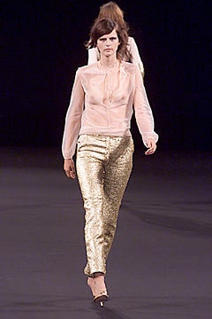 pink sheer blouse with gold pants