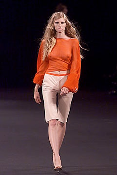 orange silk fitted top and beige tailored shorts
