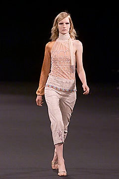 fitted orange silk top with beige relaxed pants