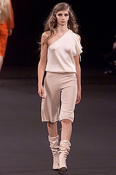 white asymmetric top with beige shorts