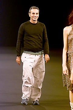 black fitted sweater and white cargo pants