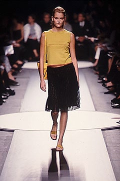 yellow fitted top black fringed skirt