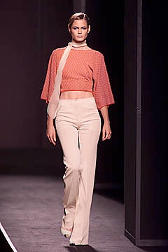 orange cropped top with beige pants