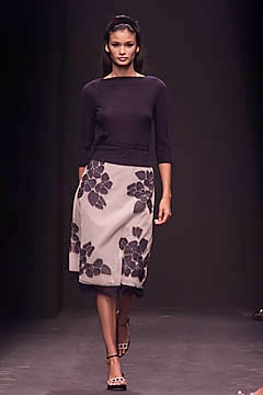 black fitted top with beige flared skirt
