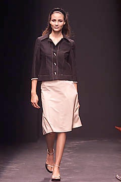 black fitted jacket and beige a-line skirt