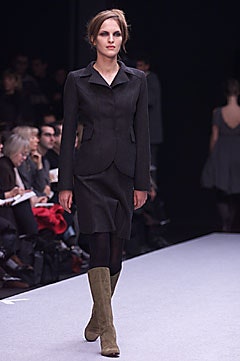 black fitted midi dress with green boots