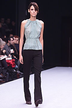 fitted green silk top with black pants