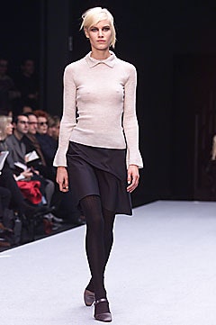 beige fitted top with black skirt