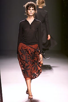 black fitted top and red pleated skirt
