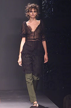 black silk fitted top with green pants