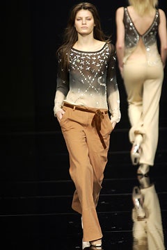 black and white embellished top with brown pants