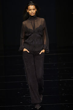 black sheer blouse and relaxed pants