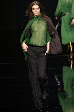 green silk fitted top with black pants