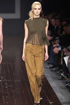 green sheer top with brown pants