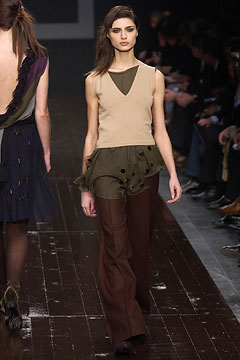 beige ruffled top with brown flared pants