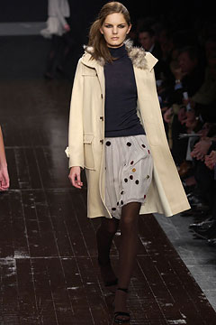beige wool coat with pleated skirt
