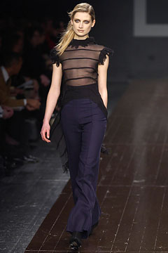 black sheer top and navy flared pants