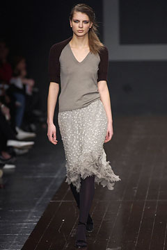 gray fitted top with beige ruffled skirt